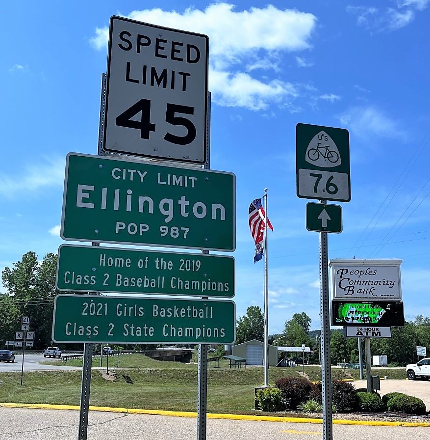 Road sign: City of Ellington, population 987.