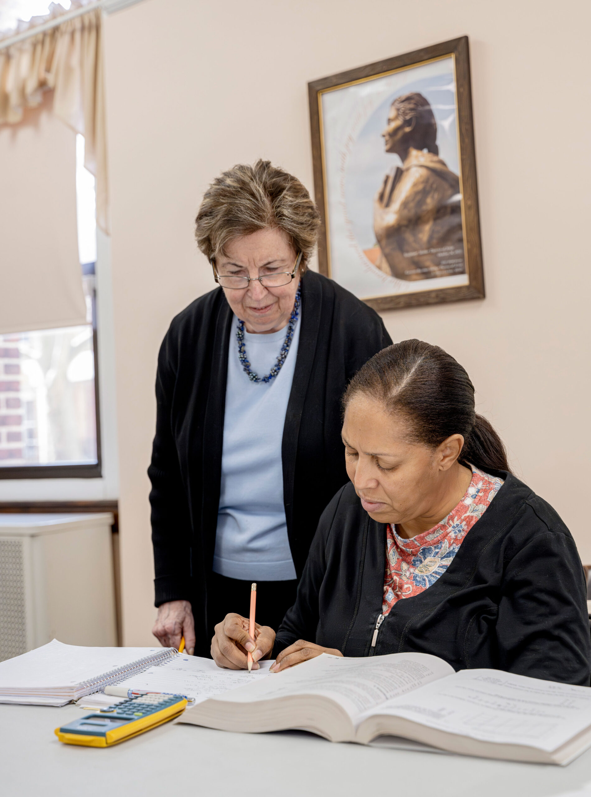 Volunteer GED math teacher Theresa Jaffe works with a student at SSND Educational Center.