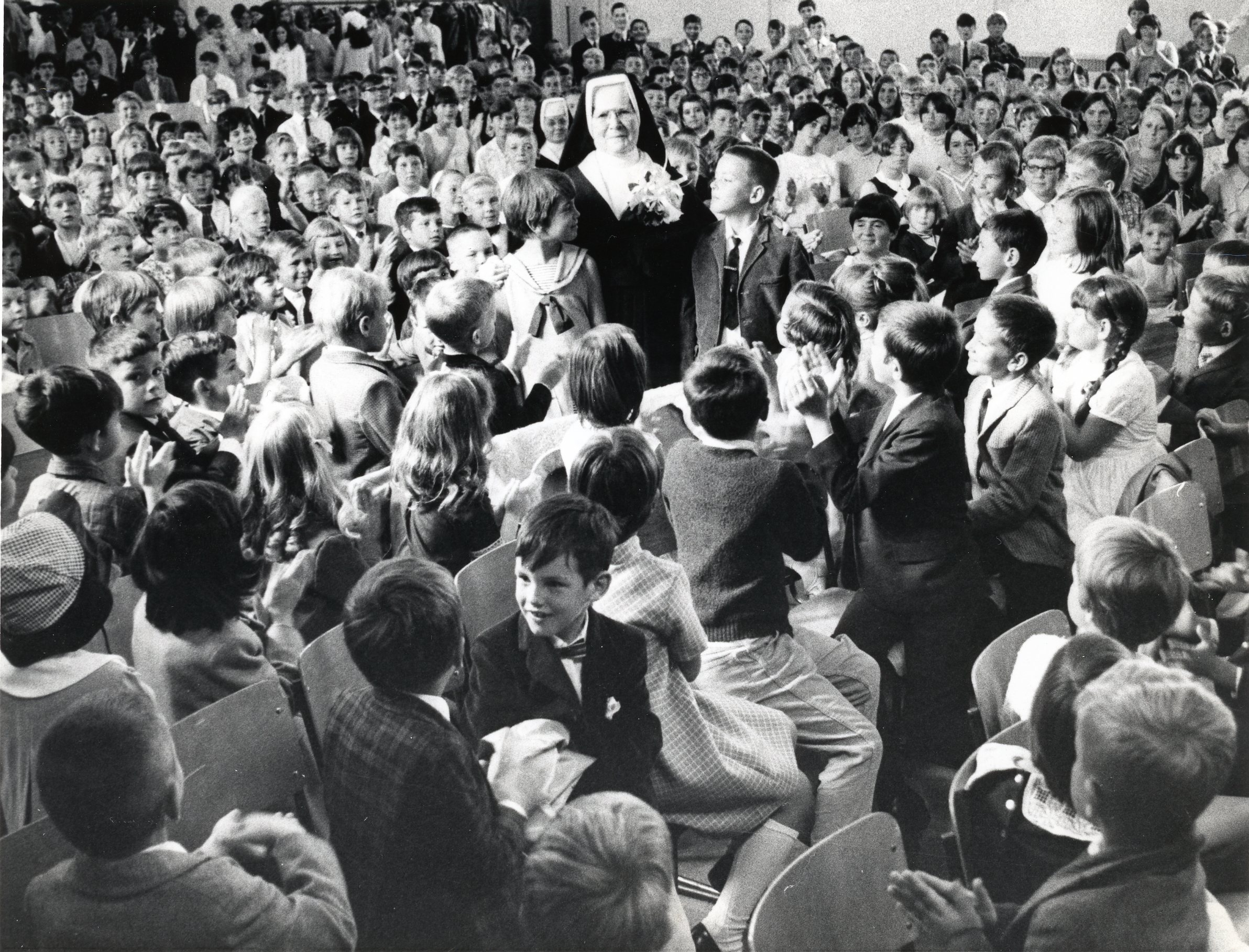 Sister Bridilia McCormick and her students at her retirement as principal of Notre Dame School, Kitchener, Ontario, in 1968.