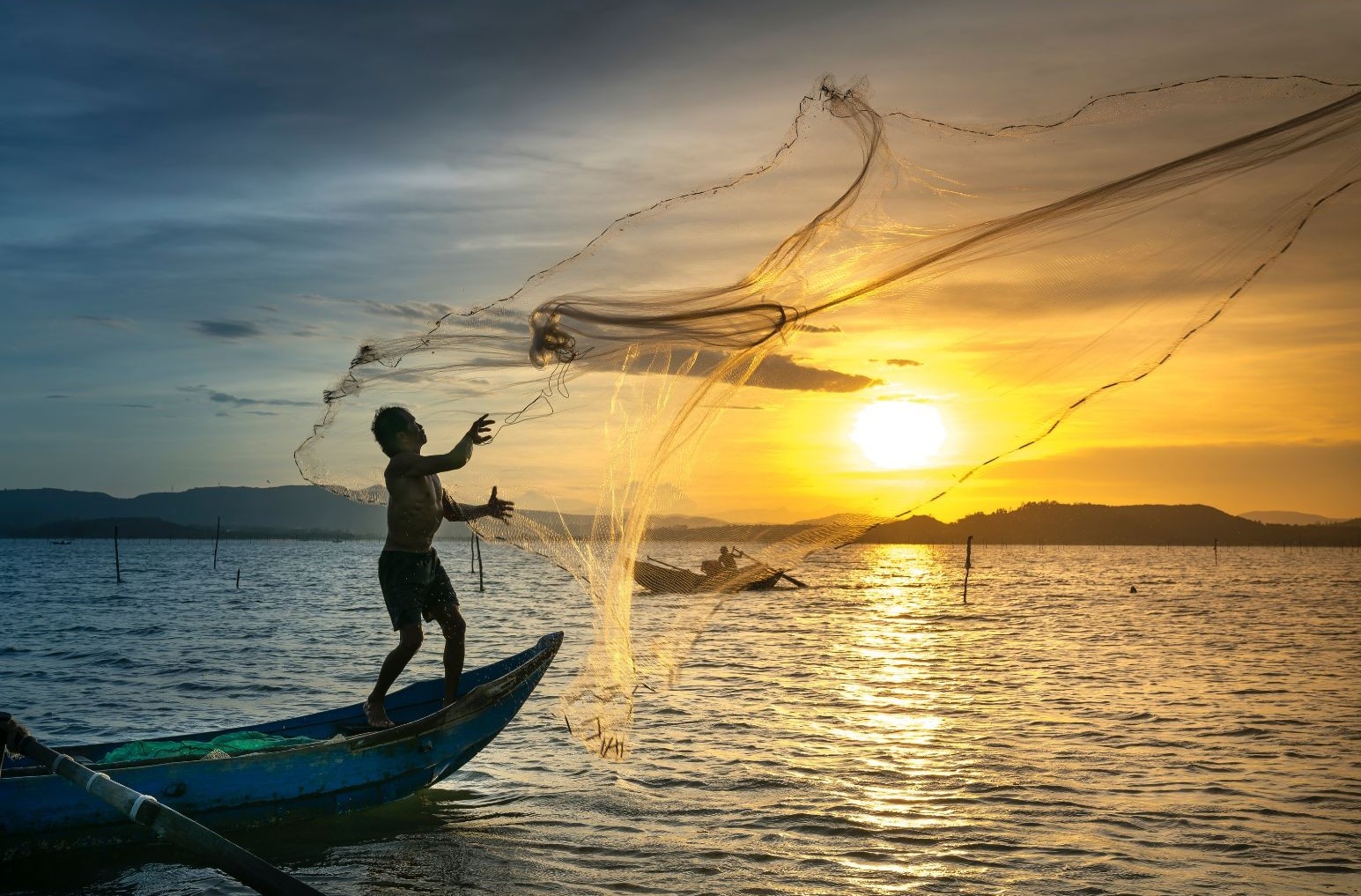 Fisherman throwing fishnet